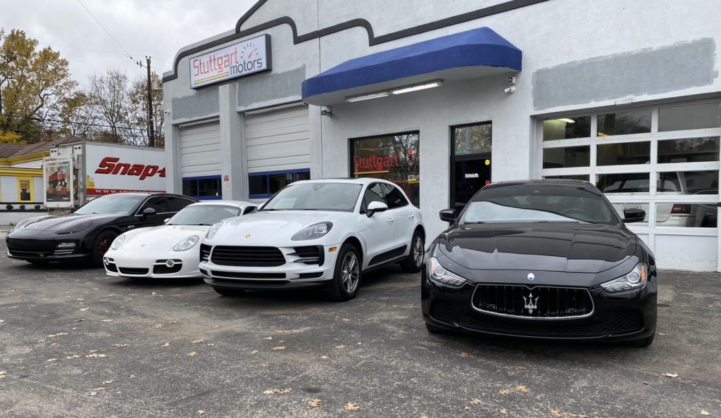 a lineup of high-end premium cars outside the shop
